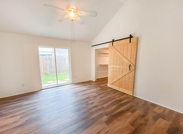 7331 Burkridge Dr, Houston, TX 77041 - empty room with a barn door, a ceiling fan, dark wood finished floors, baseboards, and high vaulted ceiling
