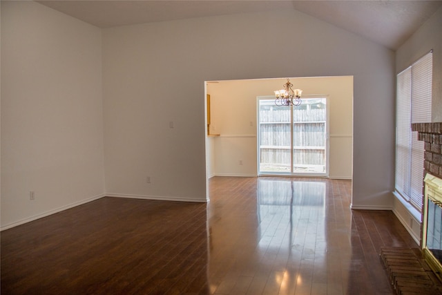 7331 Burkridge Dr, Houston, TX 77041 - spare room featuring a chandelier, dark wood-style floors, vaulted ceiling, and baseboards