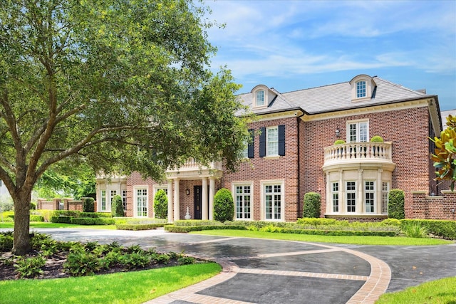 24 Farnham Park Dr, Houston, TX 77024 - georgian-style home featuring brick siding, a high end roof, and uncovered parking