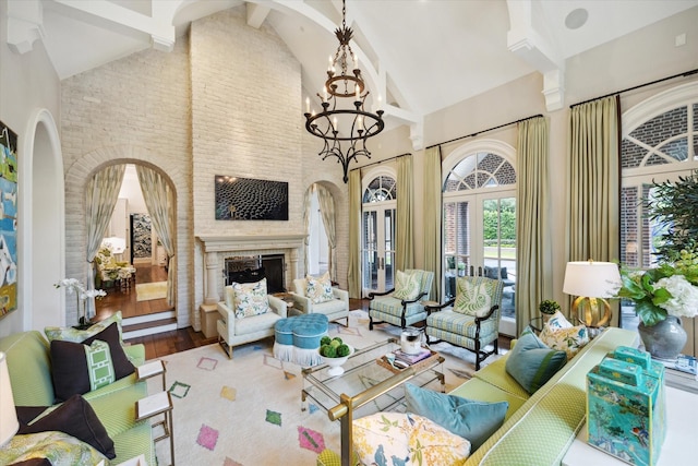 24 Farnham Park Dr, Houston, TX 77024 - living room featuring high vaulted ceiling, a chandelier, wood finished floors, beamed ceiling, and a brick fireplace