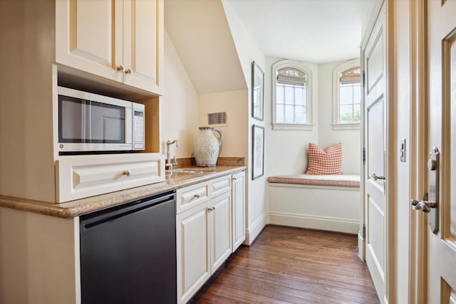 24 Farnham Park Dr, Houston, TX 77024 - kitchen featuring stainless steel microwave, dishwasher, a sink, dark wood finished floors, and white cabinets