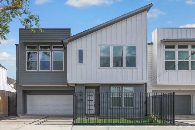 306 W Donovan St, Houston, TX 77091 - view of property featuring a garage, board and batten siding, concrete driveway, and a fenced front yard
