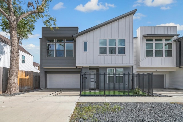 306 W Donovan St, Houston, TX 77091 - view of front of home with board and batten siding, an attached garage, driveway, and a fenced front yard