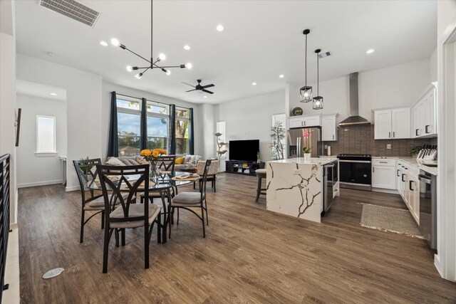 306 W Donovan St, Houston, TX 77091 - dining space featuring a chandelier, recessed lighting, and dark wood finished floors