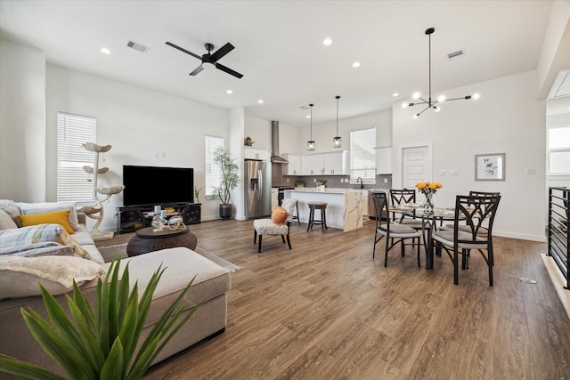 306 W Donovan St, Houston, TX 77091 - living room featuring a ceiling fan, recessed lighting, wood finished floors, and a chandelier