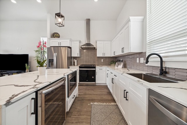 306 W Donovan St, Houston, TX 77091 - kitchen featuring beverage cooler, stainless steel appliances, wall chimney exhaust hood, a sink, and tasteful backsplash