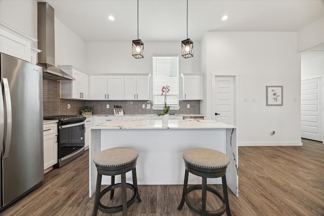 306 W Donovan St, Houston, TX 77091 - kitchen featuring stove, freestanding refrigerator, wall chimney exhaust hood, a breakfast bar, and decorative backsplash