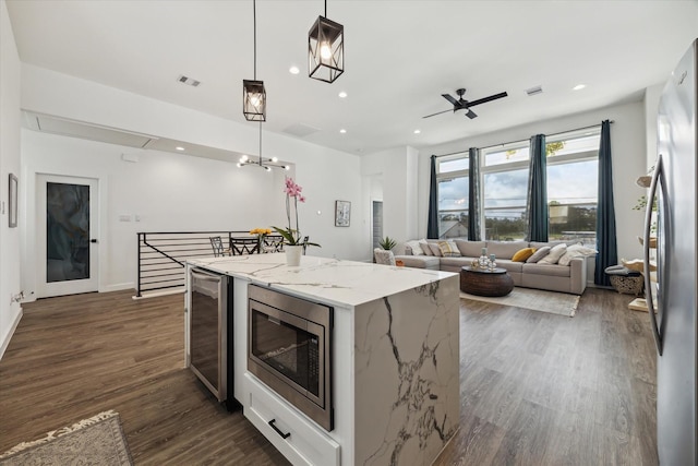 306 W Donovan St, Houston, TX 77091 - kitchen featuring stainless steel appliances, beverage cooler, open floor plan, a kitchen island, and dark wood-style floors