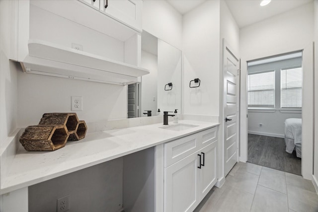 306 W Donovan St, Houston, TX 77091 - ensuite bathroom featuring double vanity, tile patterned floors, and baseboards