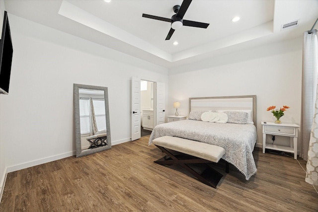 306 W Donovan St, Houston, TX 77091 - bedroom with a tray ceiling, wood finished floors, recessed lighting, baseboards, and ensuite bathroom