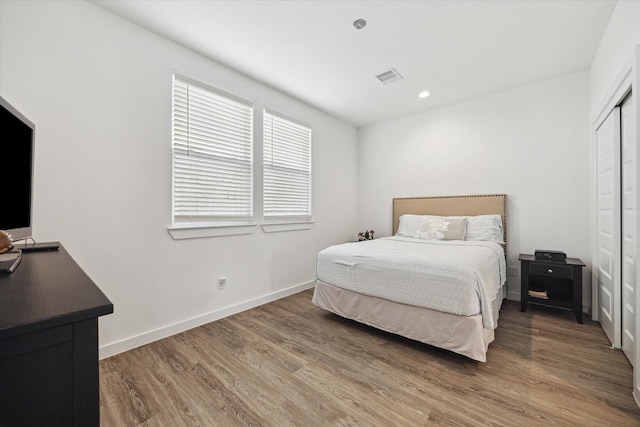 306 W Donovan St, Houston, TX 77091 - bedroom featuring wood finished floors, a closet, and baseboards