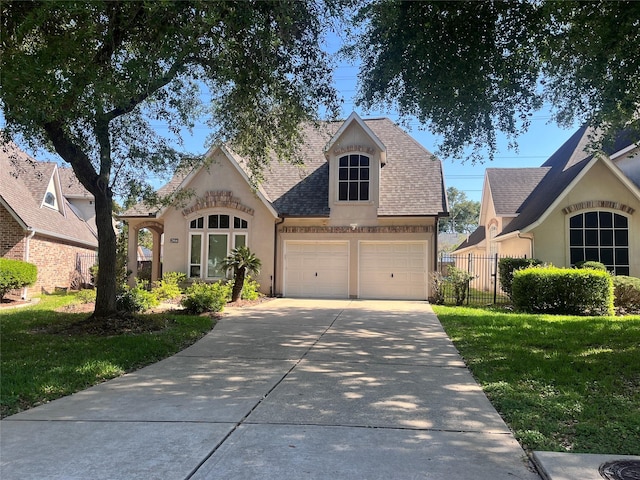 2914 Renoir, Sugar Land, TX 77479 - french country inspired facade with stucco siding, concrete driveway, roof with shingles, and an attached garage