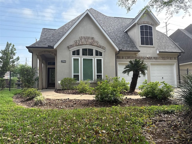 2914 Renoir, Sugar Land, TX 77479 - view of front of property with roof with shingles, stucco siding, and an attached garage