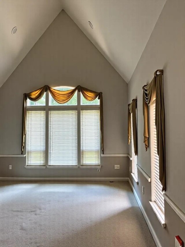 2914 Renoir, Sugar Land, TX 77479 - empty room with vaulted ceiling, carpet, and plenty of natural light