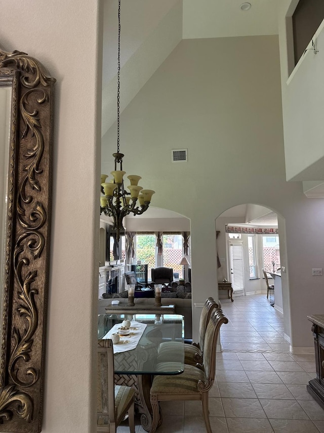 2914 Renoir, Sugar Land, TX 77479 - dining room featuring arched walkways, high vaulted ceiling, and a chandelier