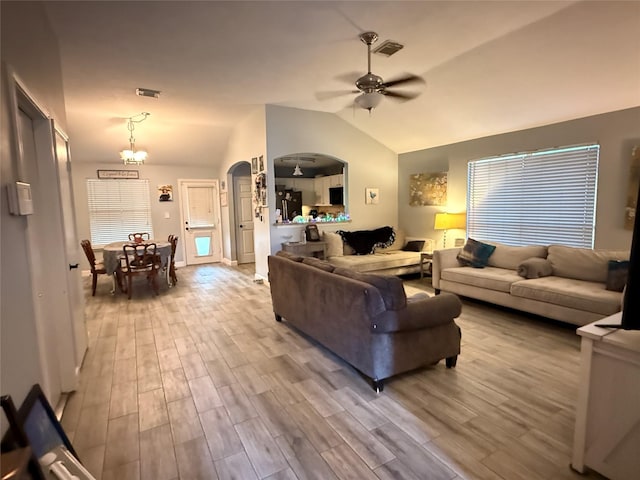 207 Leisure Ln, Montgomery, TX 77356 - living area with ceiling fan, arched walkways, lofted ceiling, wood finished floors, and a chandelier