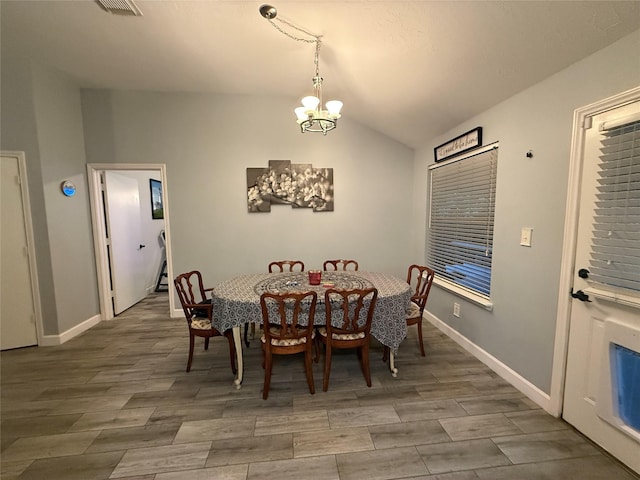 207 Leisure Ln, Montgomery, TX 77356 - dining space with a chandelier, vaulted ceiling, wood finished floors, and baseboards