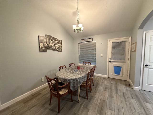 207 Leisure Ln, Montgomery, TX 77356 - dining room with lofted ceiling, a chandelier, wood finished floors, and baseboards