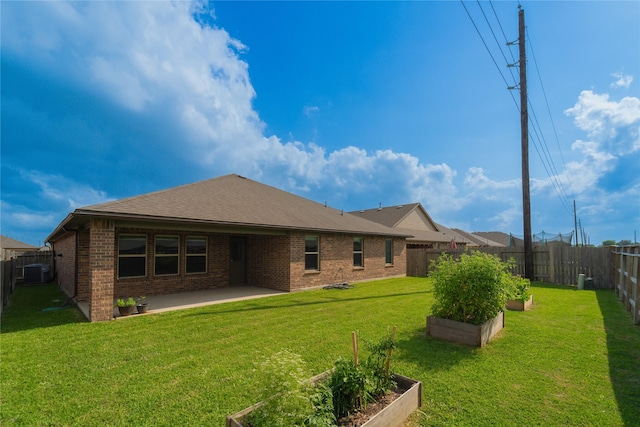 1318 Bellingham Park Dr, Missouri City, TX 77459 - back of property with a garden, a patio area, brick siding, cooling unit, and a shingled roof