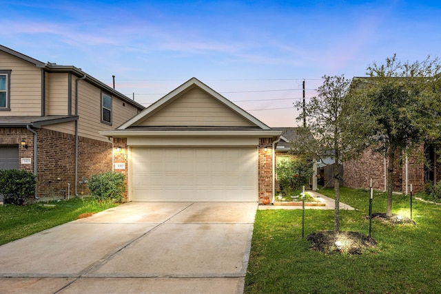 5327 Castle Discordia St, Katy, TX 77493 - view of front facade featuring driveway, a lawn, and brick siding