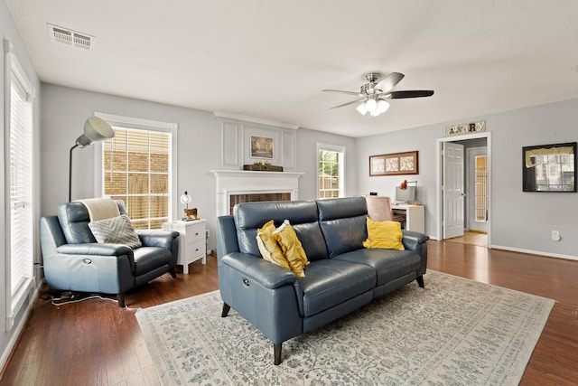 10503 Minturn Ln, Houston, TX 77064 - living area with a ceiling fan, dark wood finished floors, a brick fireplace, and baseboards