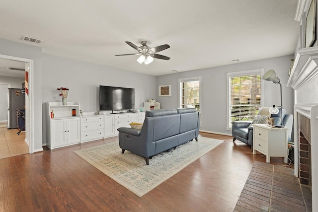 10503 Minturn Ln, Houston, TX 77064 - living room featuring a ceiling fan, dark wood-style floors, and baseboards