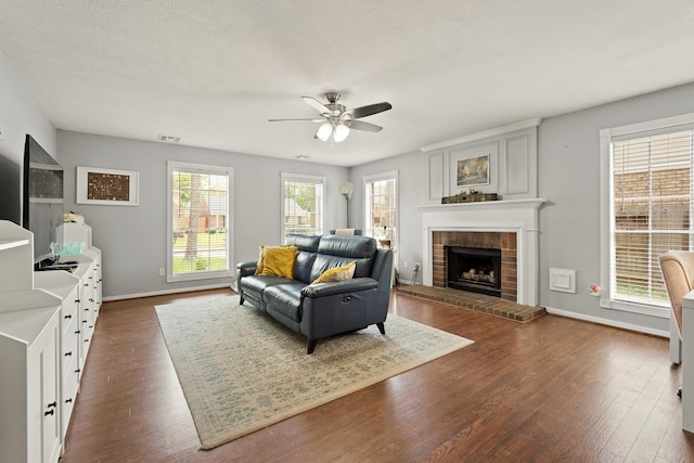 10503 Minturn Ln, Houston, TX 77064 - living room featuring ceiling fan, dark wood finished floors, a fireplace, and baseboards