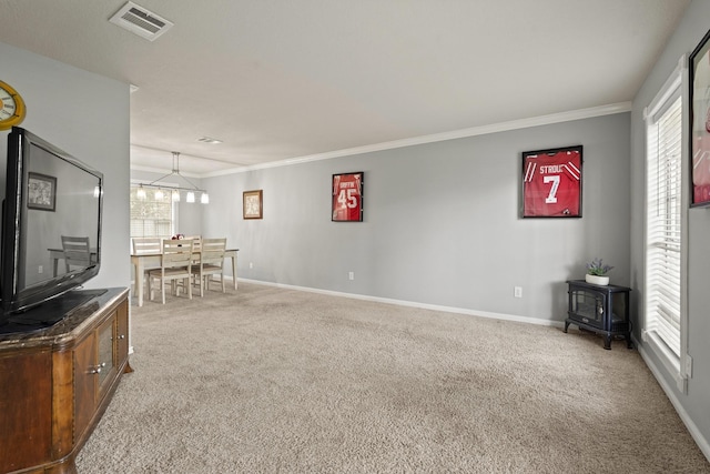 10503 Minturn Ln, Houston, TX 77064 - carpeted living area featuring a wood stove, ornamental molding, baseboards, and a chandelier