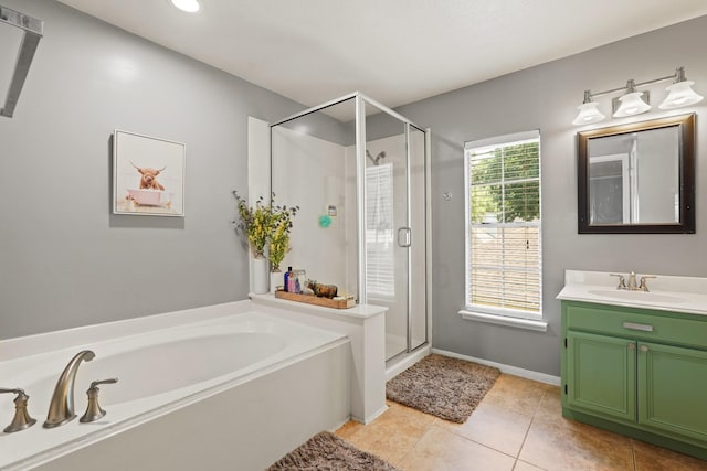 10503 Minturn Ln, Houston, TX 77064 - full bathroom featuring a bath, vanity, a stall shower, tile patterned flooring, and baseboards