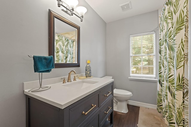 10503 Minturn Ln, Houston, TX 77064 - full bathroom with vanity, toilet, baseboards, and wood finished floors