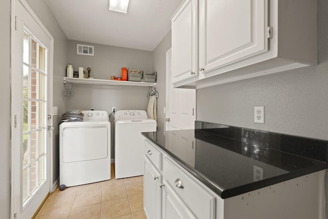 10503 Minturn Ln, Houston, TX 77064 - laundry area featuring washer and dryer, light tile patterned flooring, and cabinet space