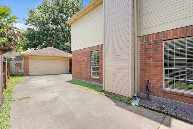 10503 Minturn Ln, Houston, TX 77064 - view of home's exterior featuring brick siding, an outdoor structure, and a detached garage