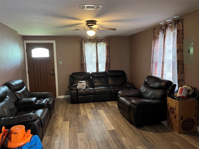 309 Aycock St, Clute, TX 77531 - living area featuring a ceiling fan, wood finished floors, and electric panel