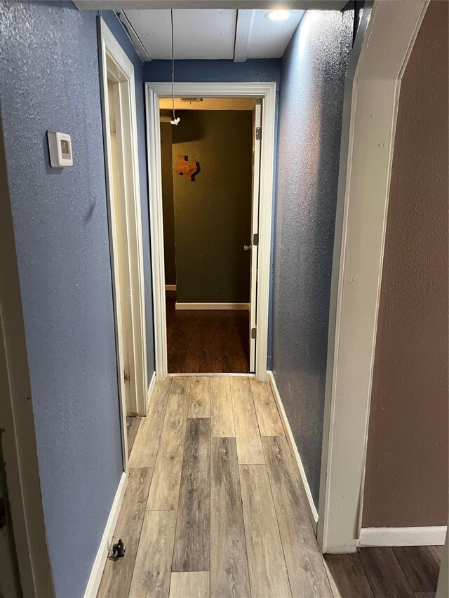309 Aycock St, Clute, TX 77531 - corridor with wood-type flooring, a textured wall, attic access, and baseboards