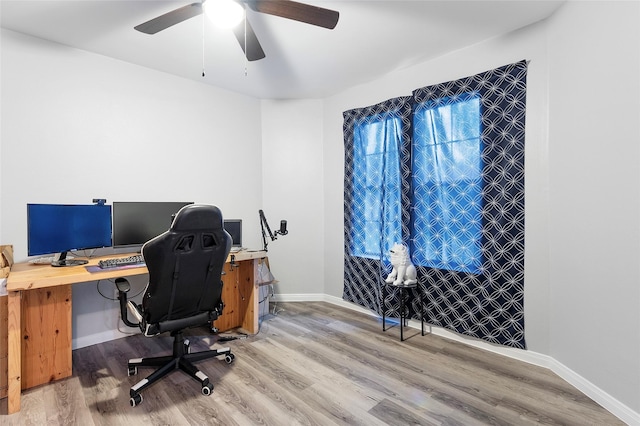 1402 Osborne Dr, Friendswood, TX 77546 - office area featuring light wood-style flooring, ceiling fan, and baseboards