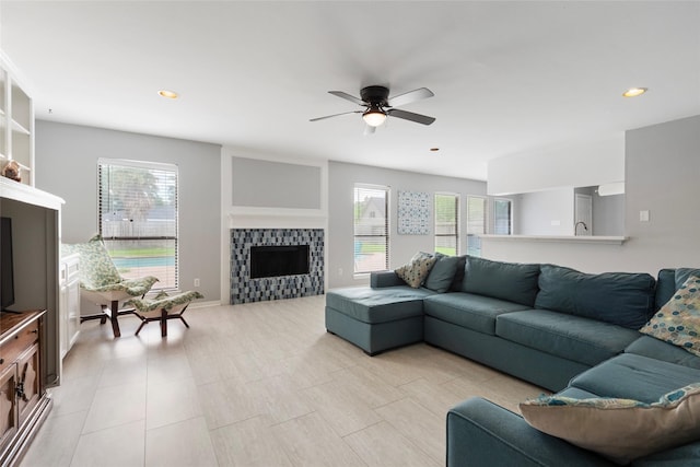 1402 Osborne Dr, Friendswood, TX 77546 - living area with a tile fireplace, healthy amount of natural light, a ceiling fan, and recessed lighting