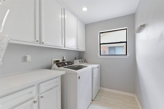 1402 Osborne Dr, Friendswood, TX 77546 - laundry room with washer and clothes dryer, cabinet space, and baseboards