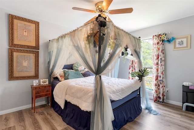 1402 Osborne Dr, Friendswood, TX 77546 - bedroom with baseboards, light wood finished floors, and a ceiling fan