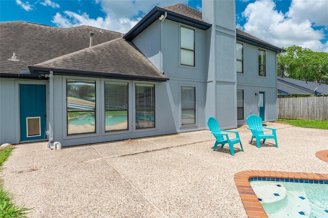 1402 Osborne Dr, Friendswood, TX 77546 - back of house with a shingled roof and a patio