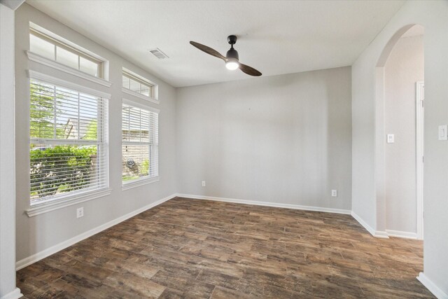 19426 Blueberry Cedar Dr, Cypress, TX 77433 - empty room featuring ceiling fan, arched walkways, dark wood-type flooring, and baseboards