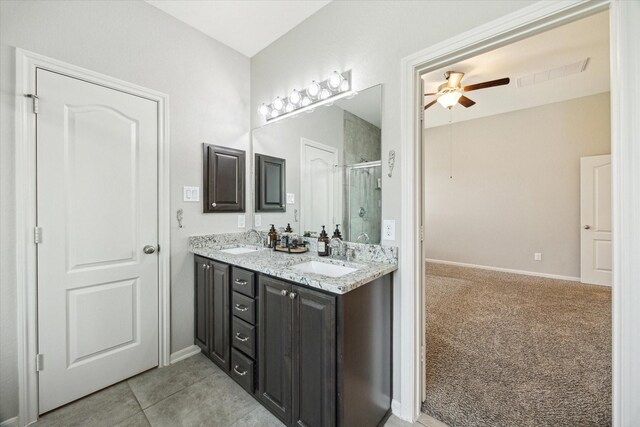 19426 Blueberry Cedar Dr, Cypress, TX 77433 - bathroom with a stall shower, double vanity, ceiling fan, baseboards, and tile patterned flooring