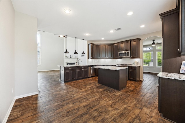 19426 Blueberry Cedar Dr, Cypress, TX 77433 - kitchen featuring appliances with stainless steel finishes, dark brown cabinets, dark wood finished floors, a sink, and recessed lighting