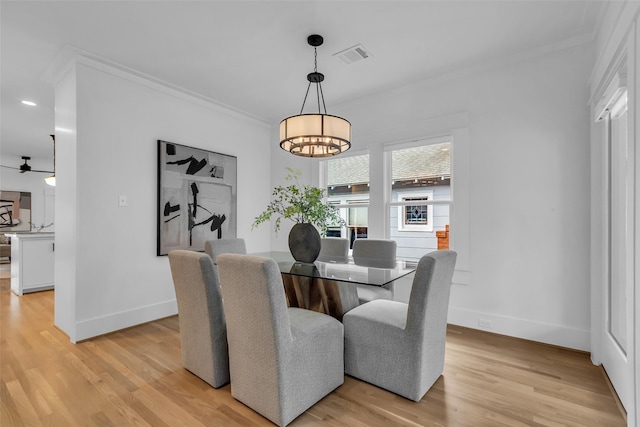 904 Willard St, Houston, TX 77006 - dining area featuring crown molding, a chandelier, light wood-style flooring, baseboards, and recessed lighting