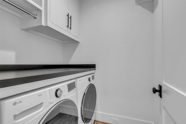 904 Willard St, Houston, TX 77006 - washroom with washing machine and clothes dryer, cabinet space, baseboards, and wood finished floors