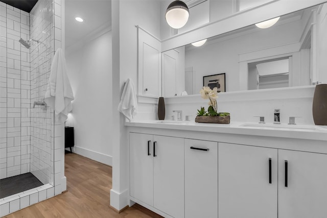 904 Willard St, Houston, TX 77006 - full bathroom featuring double vanity, tiled shower, baseboards, wood finished floors, and recessed lighting