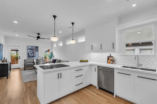 904 Willard St, Houston, TX 77006 - kitchen with stainless steel dishwasher, a sink, black electric stovetop, a peninsula, and decorative backsplash