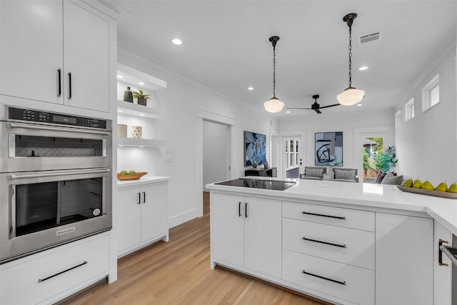 904 Willard St, Houston, TX 77006 - kitchen featuring double oven, black electric cooktop, white cabinets, light wood finished floors, and recessed lighting
