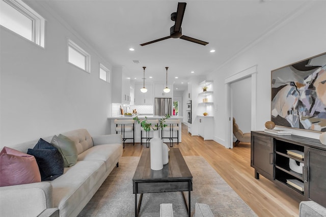 904 Willard St, Houston, TX 77006 - living room with ceiling fan, light wood-style floors, recessed lighting, crown molding, and baseboards