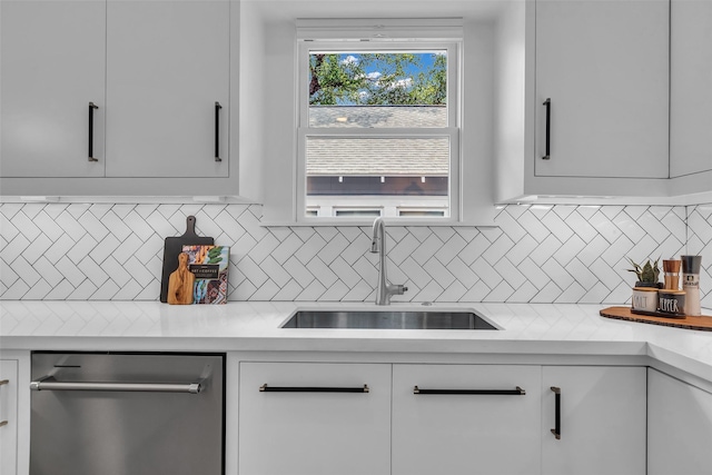 904 Willard St, Houston, TX 77006 - kitchen with a sink, stainless steel dishwasher, white cabinetry, light countertops, and decorative backsplash