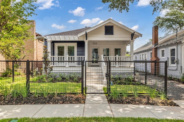 904 Willard St, Houston, TX 77006 - view of front facade featuring covered porch, a gate, a fenced front yard, and roof with shingles